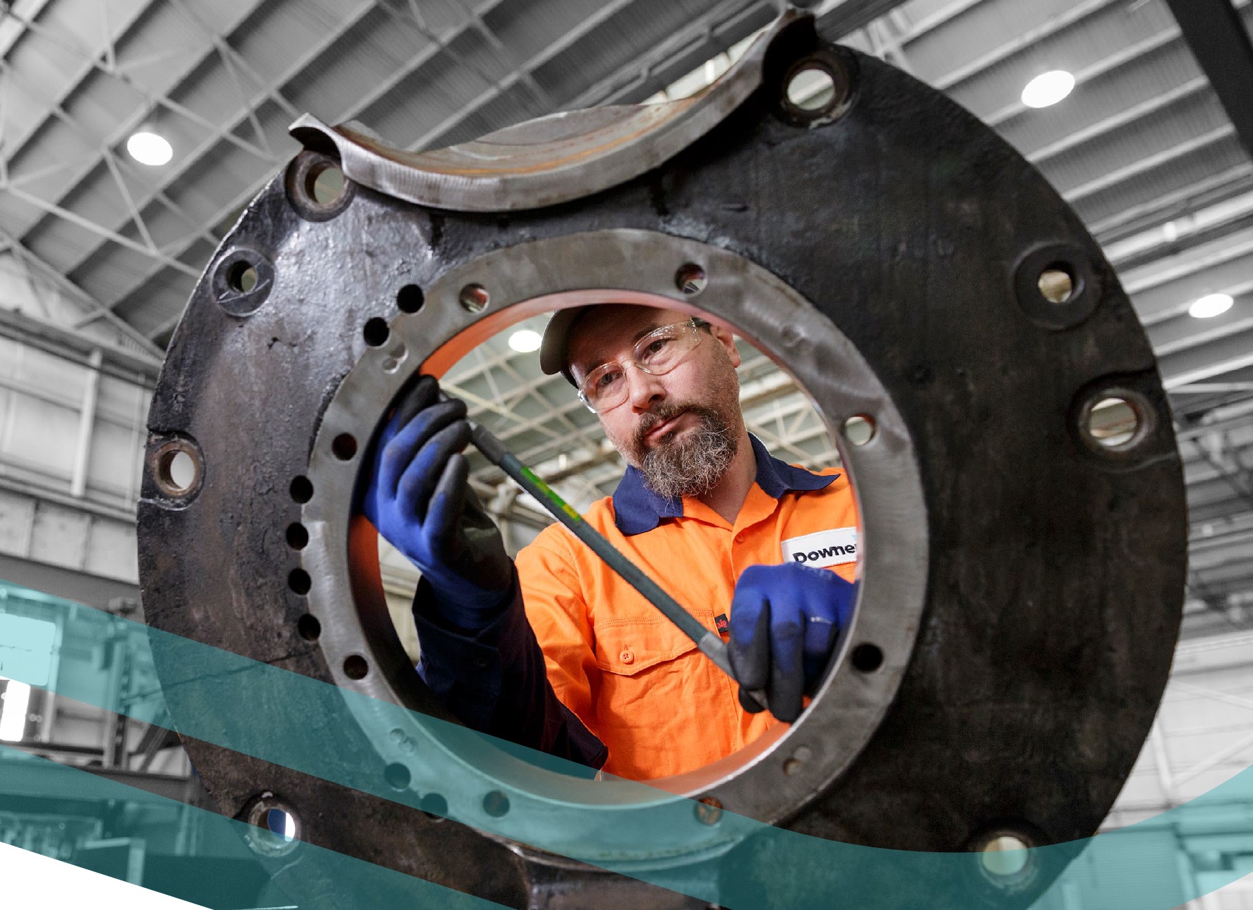 Photo of rail worker fixing a train wheel.