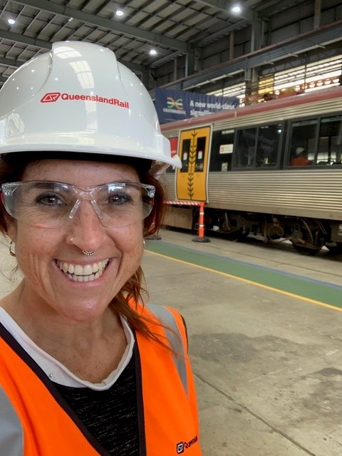 A female systems engineer on a railway platform.