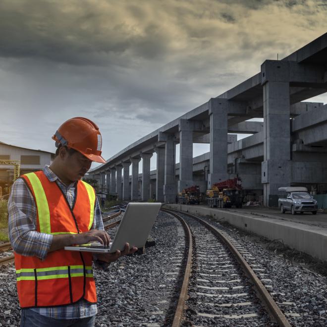 Man on track checking laptop