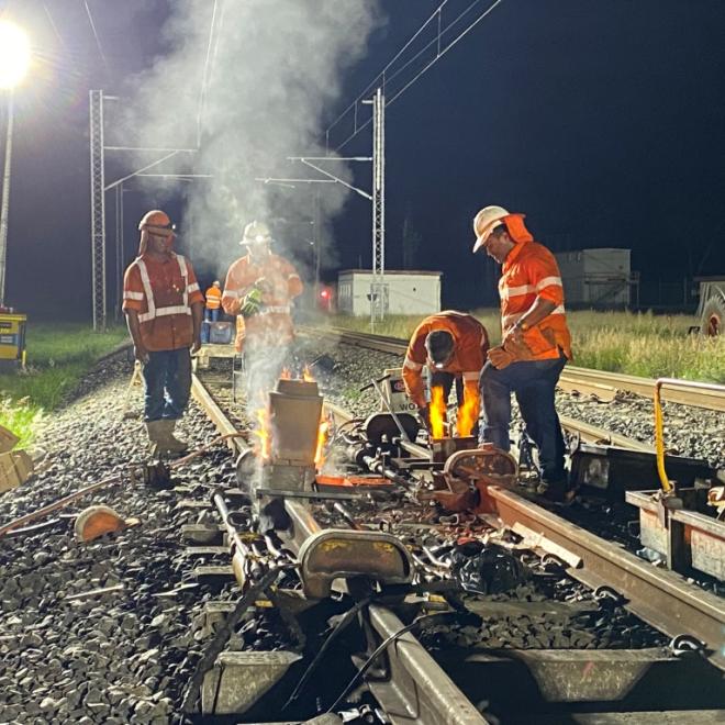 Rail track welders at night